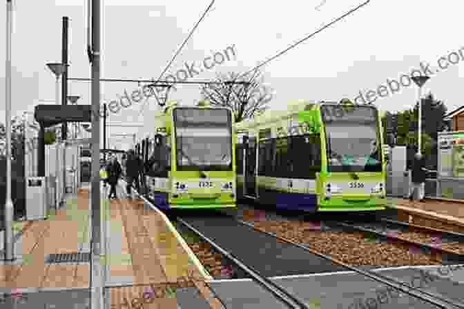 A Modern London Transport Regional Tramway (LTRT) Tram Glides Smoothly Along A Dedicated Trackway. The Tram Is Sleek, Modern, And Accessible, With A Striking Blue And Silver Livery. The Surrounding Urban Landscape Is Vibrant And Bustling, With People Walking, Cycling, And Enjoying The Public Spaces. London Transport (Regional Tramways) Victoria Findlay Wolfe